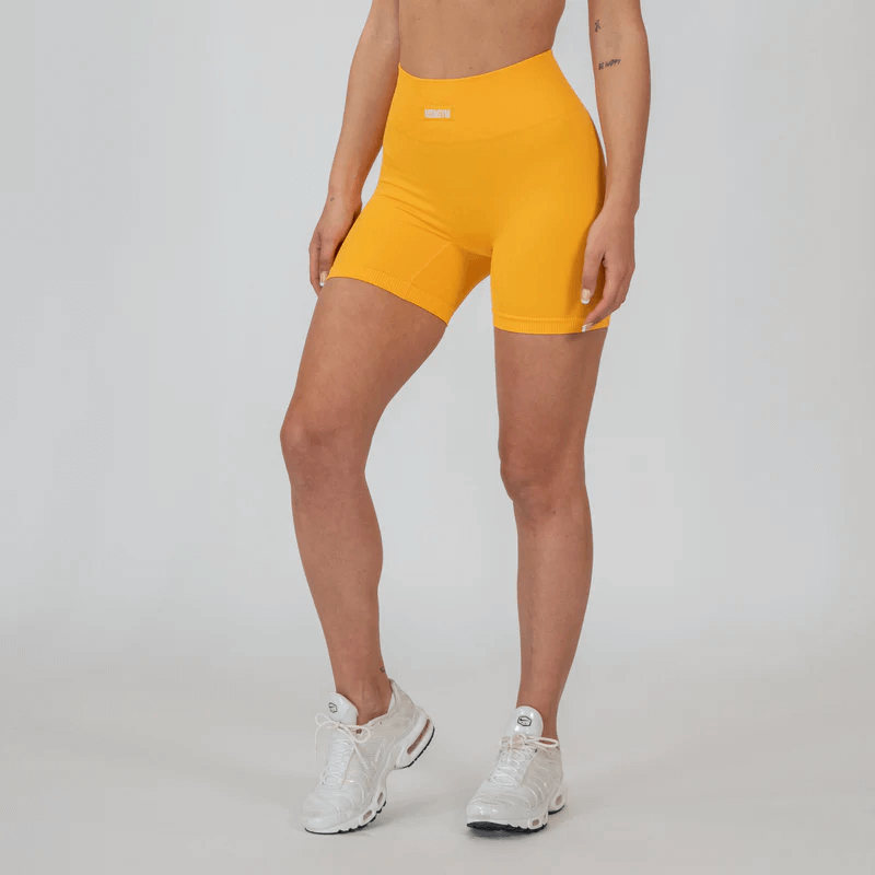 A person wearing yellow shorts Description automatically generated