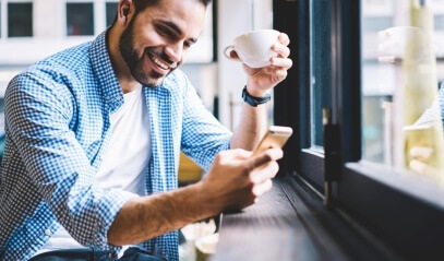 cheerful man checking phone