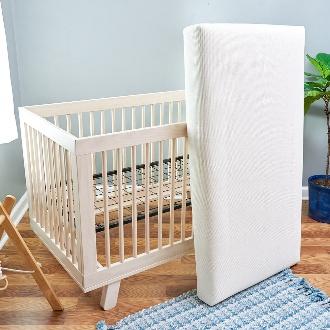 Crib mattresses leaning on crib