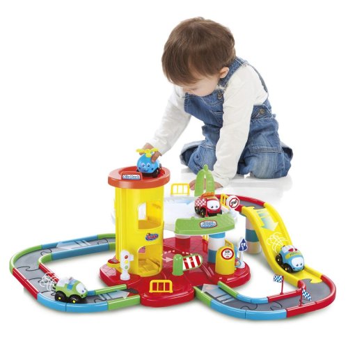Child playing with a toy car garage and track set