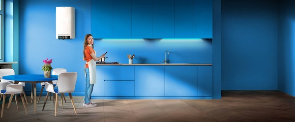 Woman in a modern kitchen with a condensing boiler, from the A2A Caldaia2A page