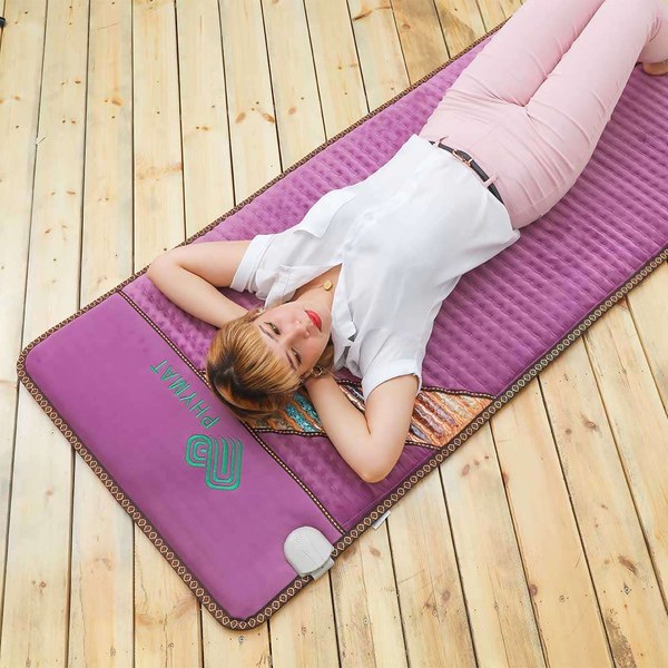 PHYMAT Amethyst Infrared PEMF Mat Pro in purple shown laid flat on a wooden floor