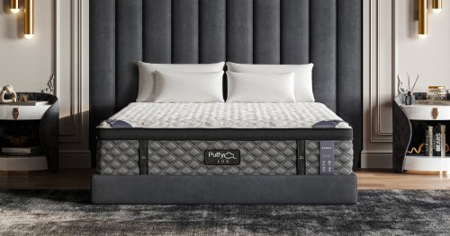 Puffy Lux Hybrid mattress with white pillows in a modern bedroom