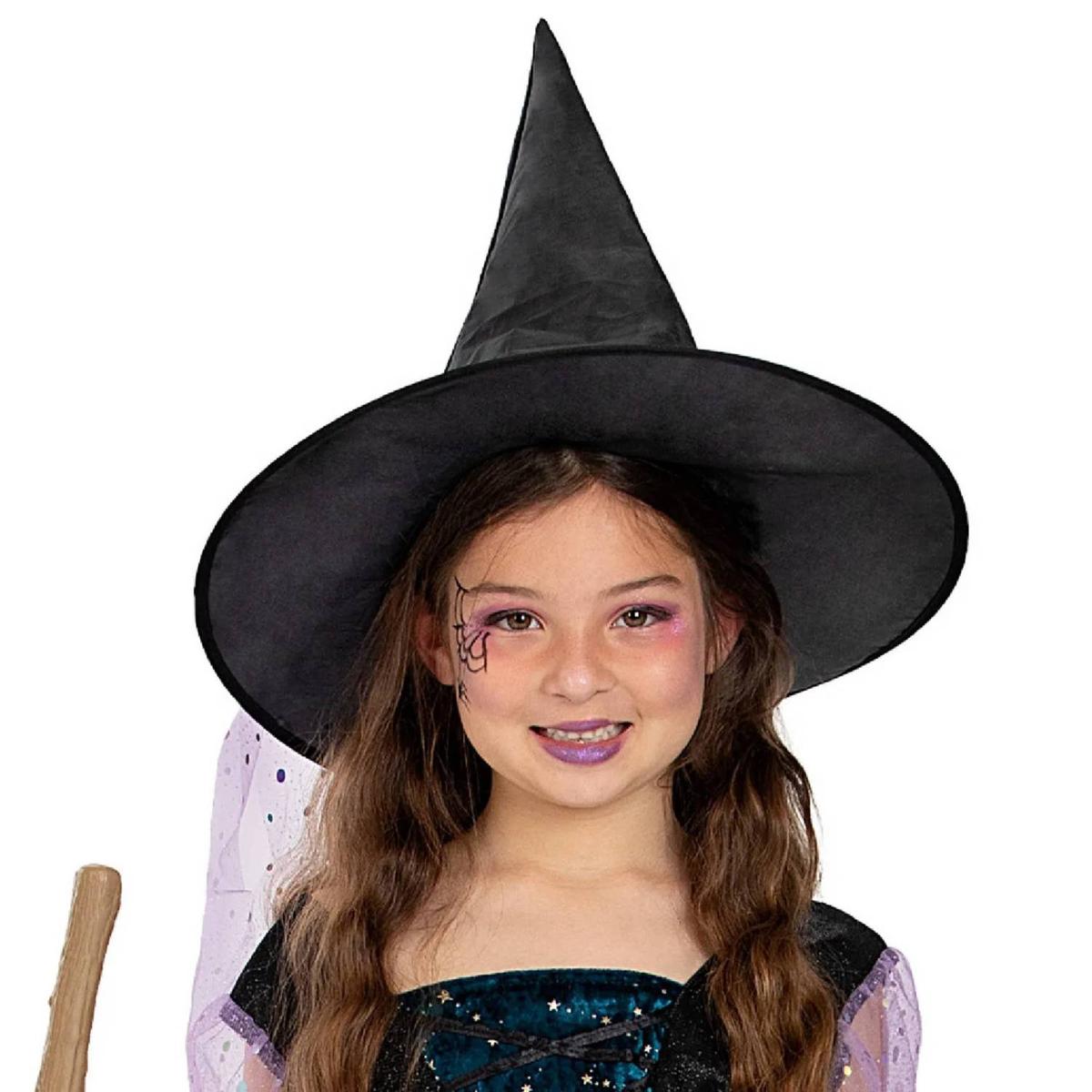 Child wearing a witch costume and hat for Halloween