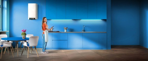 Woman in a modern kitchen with a condensing boiler, from the A2A Caldaia2A page