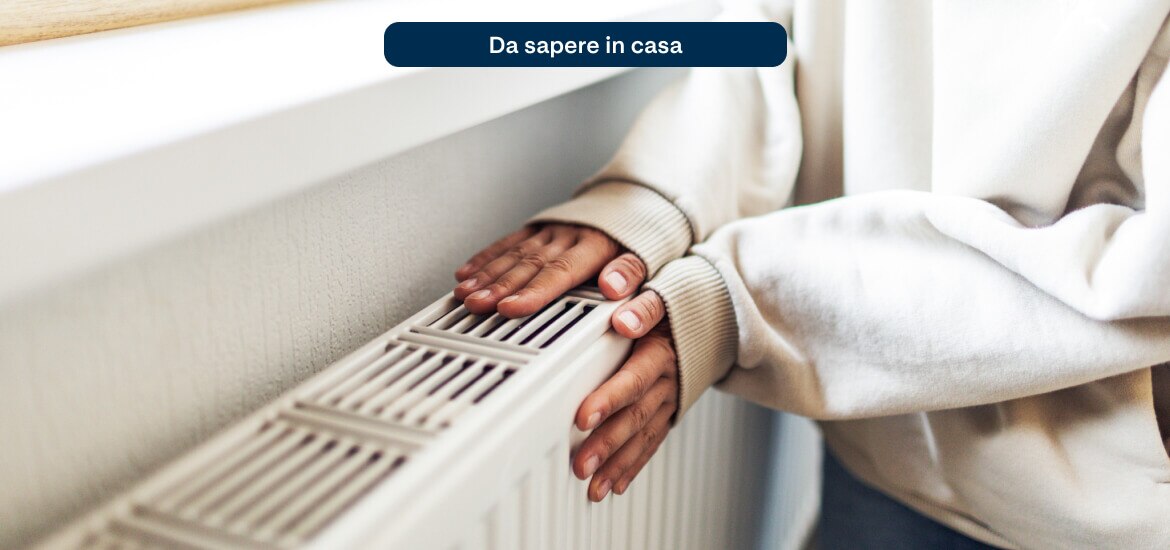 Hands warming up on a home radiator during the colder months