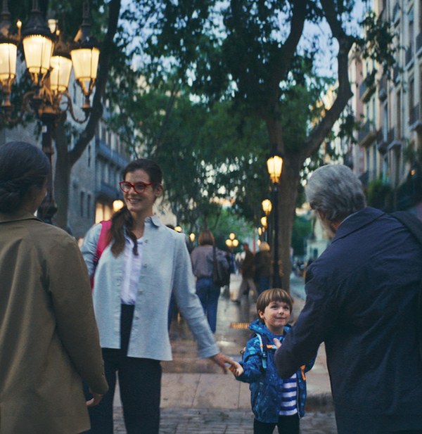 Family walking together through a city street at dusk, from an Enel campaign