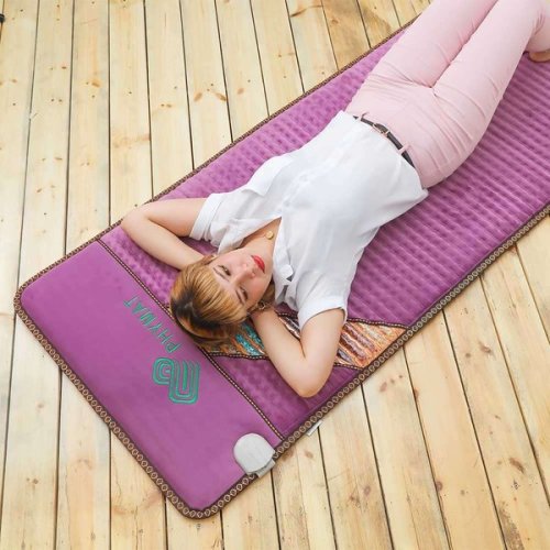 PHYMAT Amethyst Infrared PEMF Mat Pro in purple shown laid flat on a wooden floor