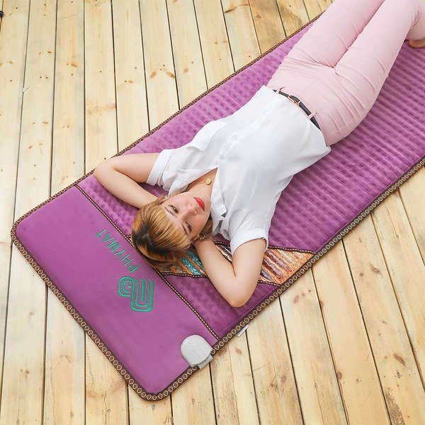 PHYMAT Amethyst Infrared PEMF Mat Pro in purple shown laid flat on a wooden floor