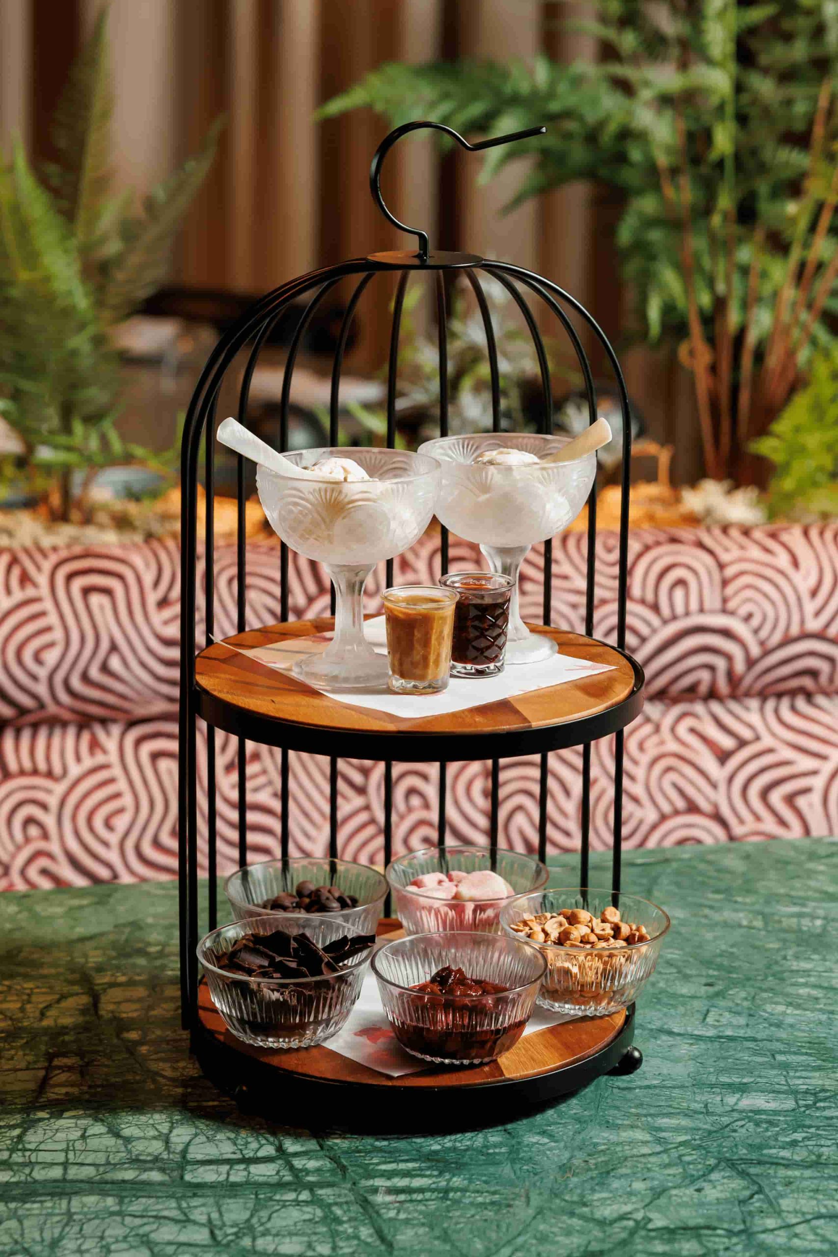 The Songbird Sundae Experience served in a birdcage stand