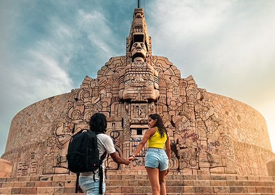 Travellers visiting a monument in Merida, Yucatan