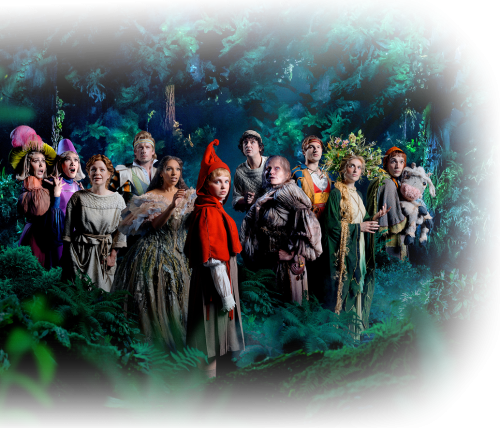 The company of Into the Woods on stage in a lush forest setting at the Noël Coward Theatre