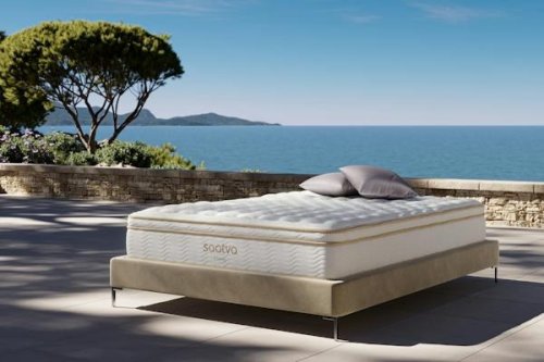 Saatva Classic mattress on a bed frame on a terrace overlooking the sea
