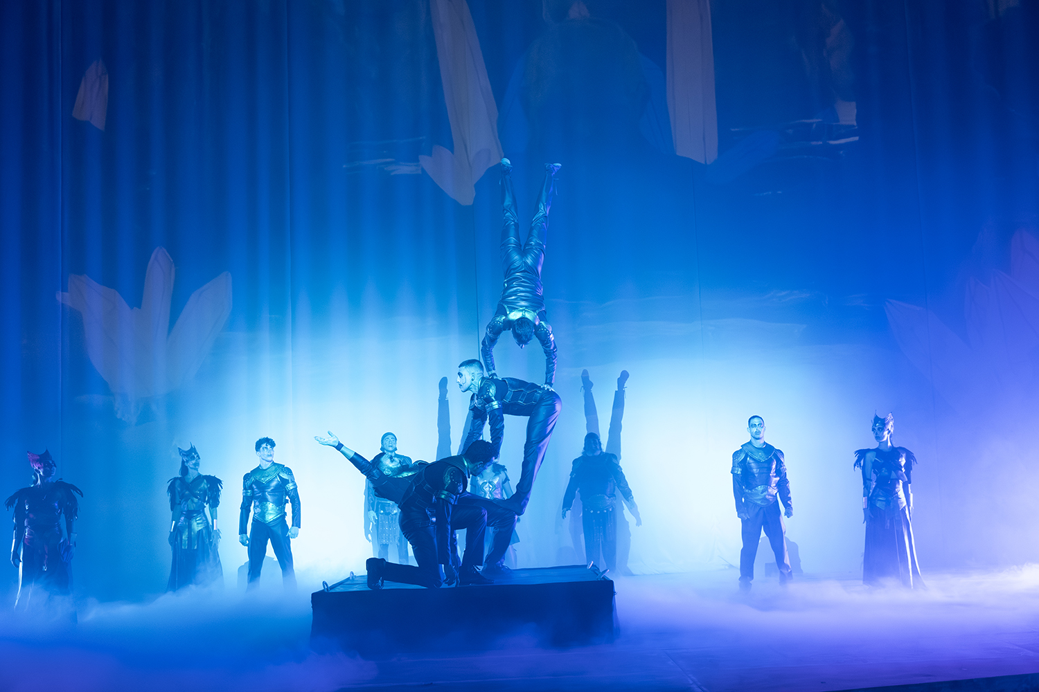Performers on a misty, blue-lit stage during a Terra Mítica Halloween show